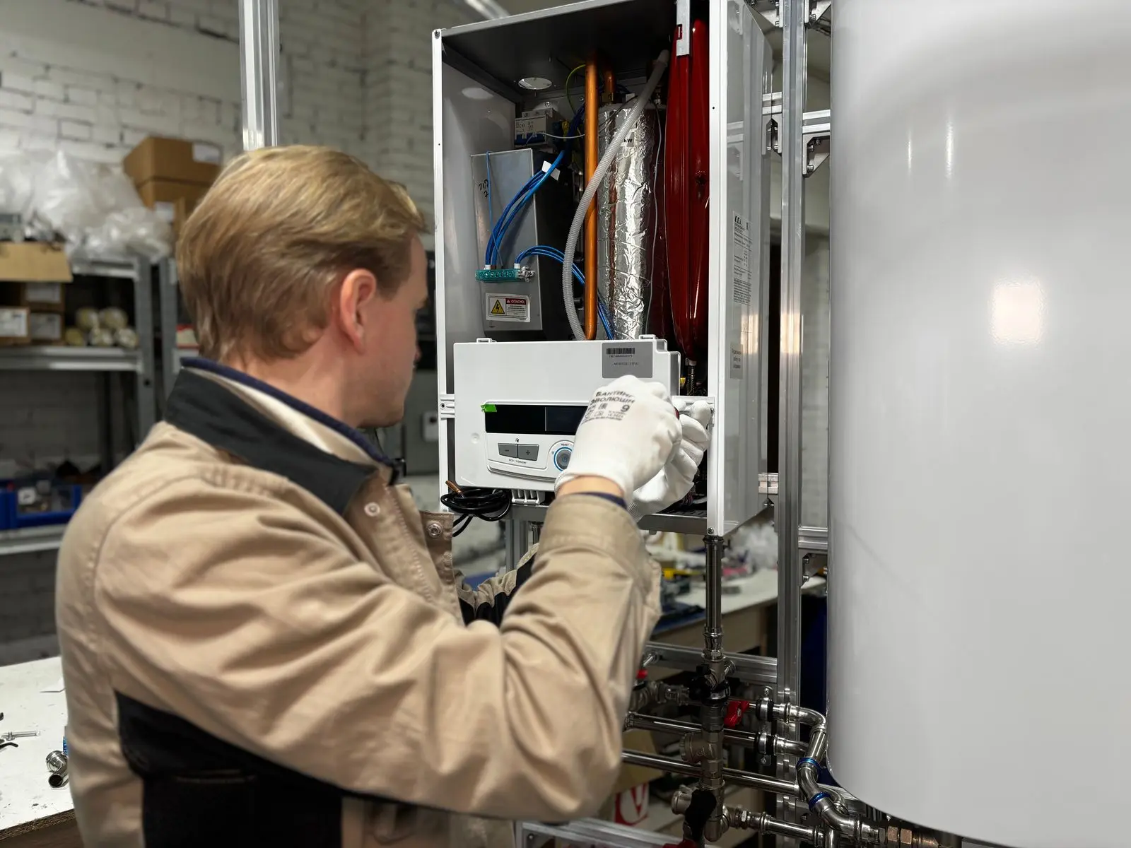 Technician servicing commercial water-heating equipment
