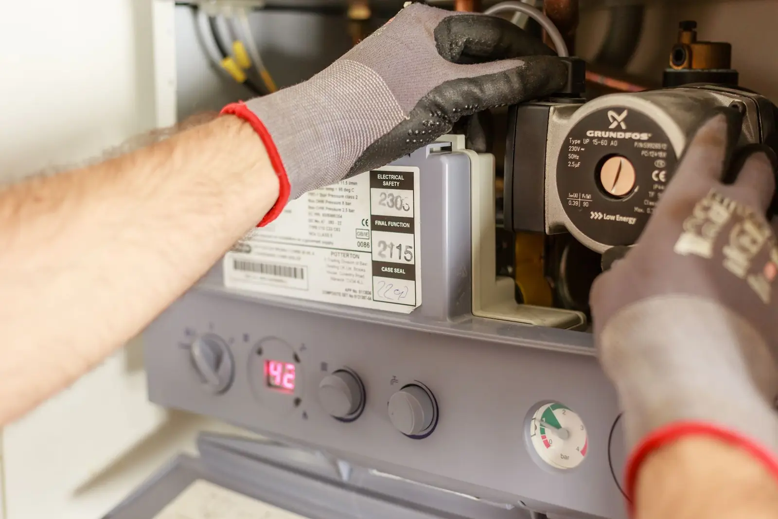 Technician checking water-heating controls and components