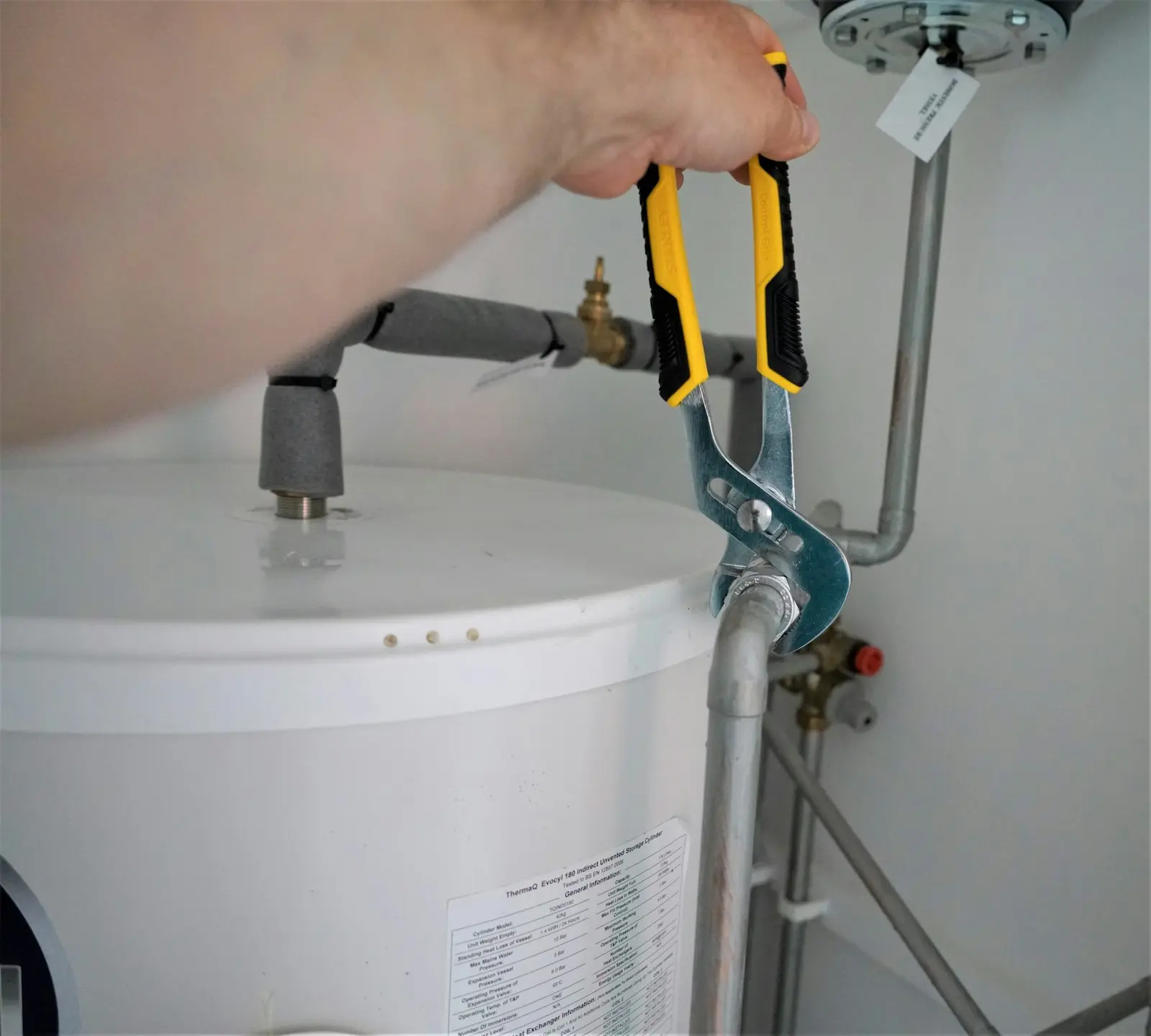 Technician repairing a connection on a water heater